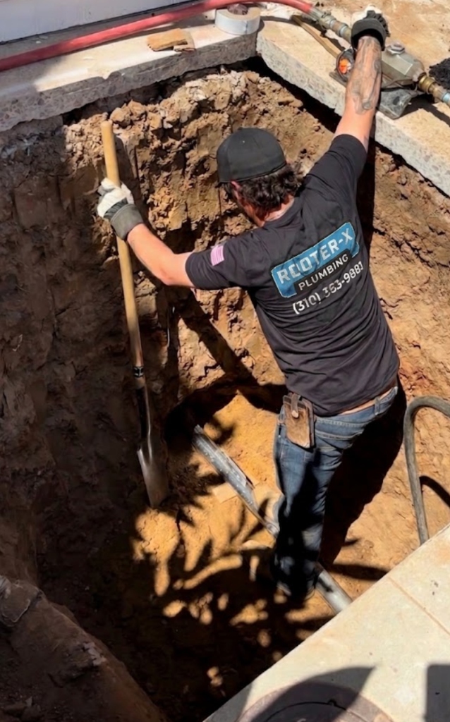 Rooter-X technician on main sewer line excavation job site